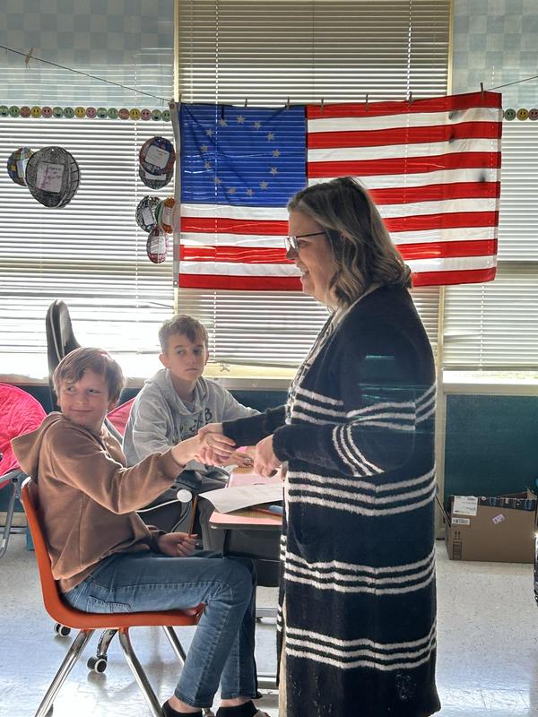 Teacher shaking a student's hand