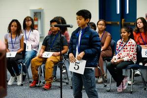 Zian Doctolero at district spelling bee speaking into mic