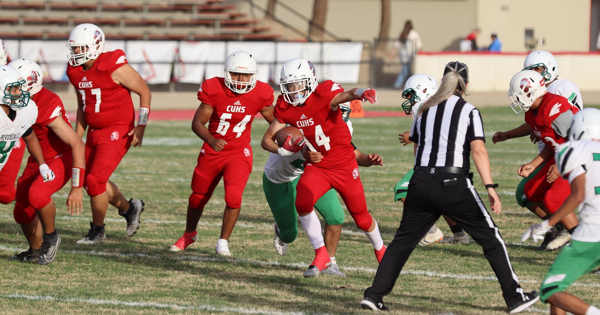  junior varsity football players in action against riverdale