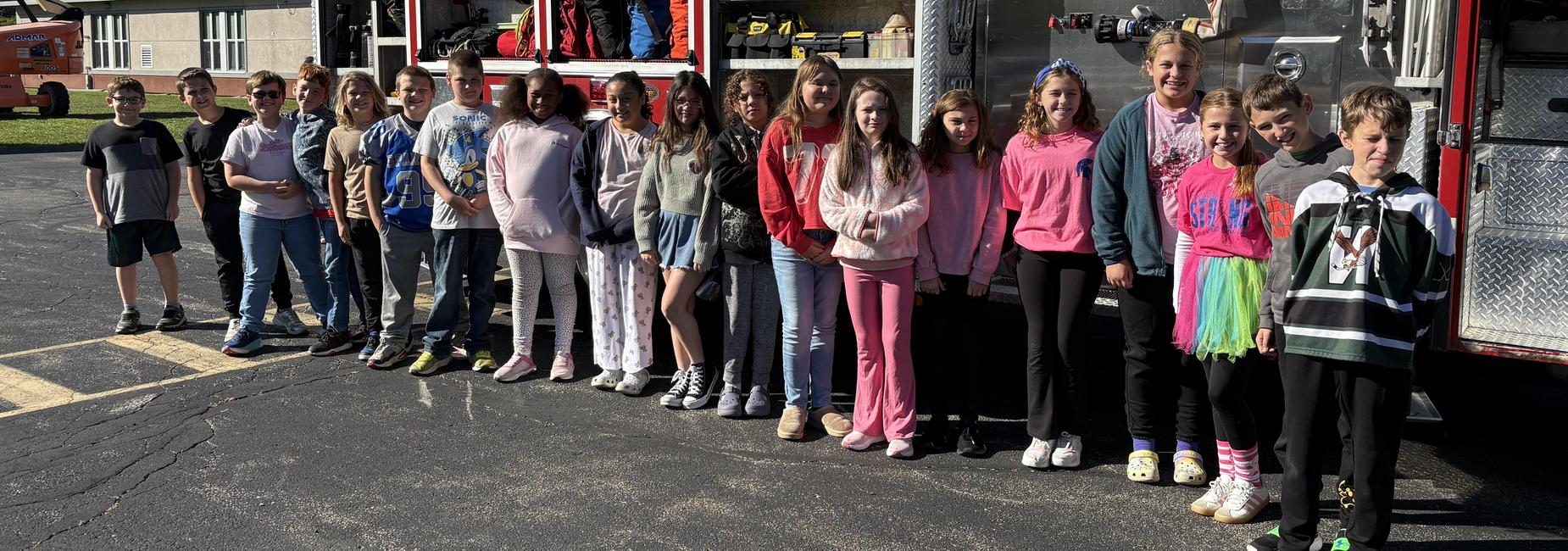 students posing in front of fire truck