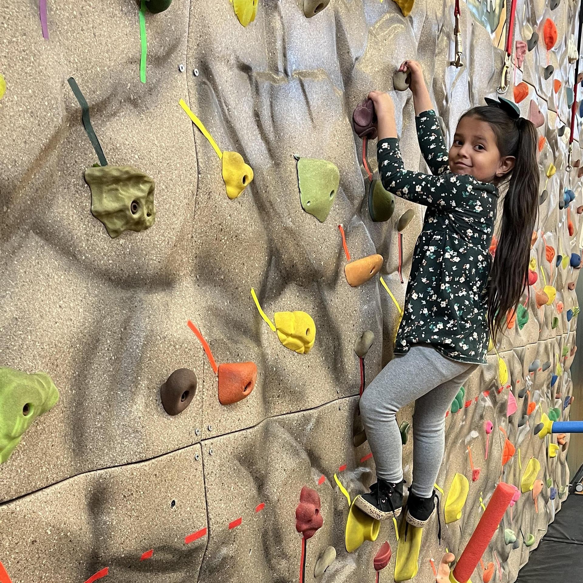 elementary student on climbing wall