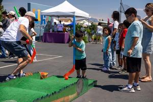Children play mini-golf at 70 Happiest Hours