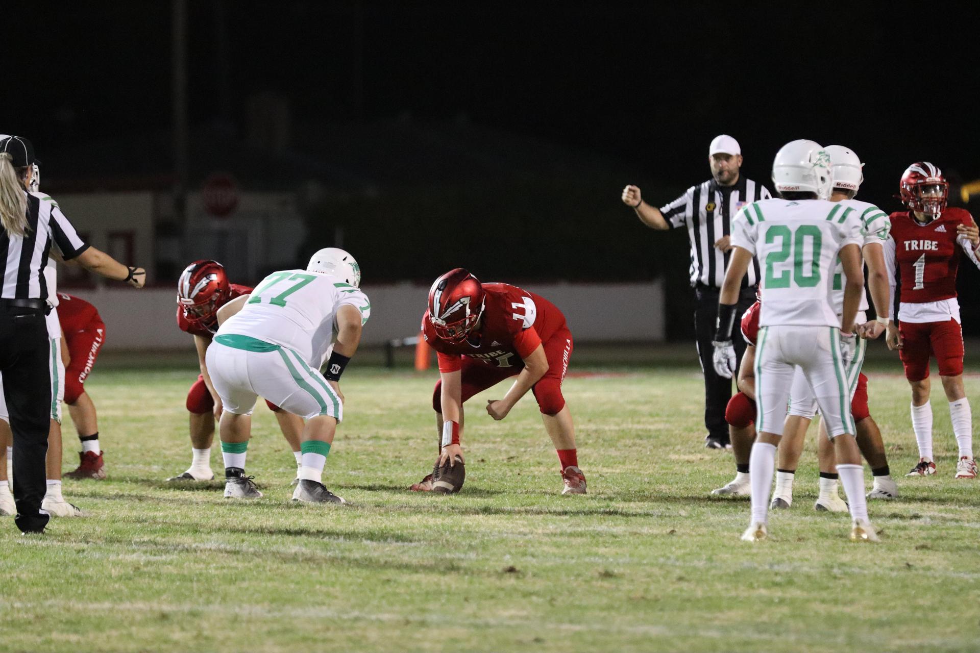 varsity football players in action against Riverdale