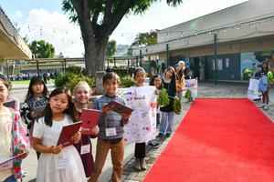 Evergreen student leaders stand at the school entrance, welcoming guests to Leadership Day.