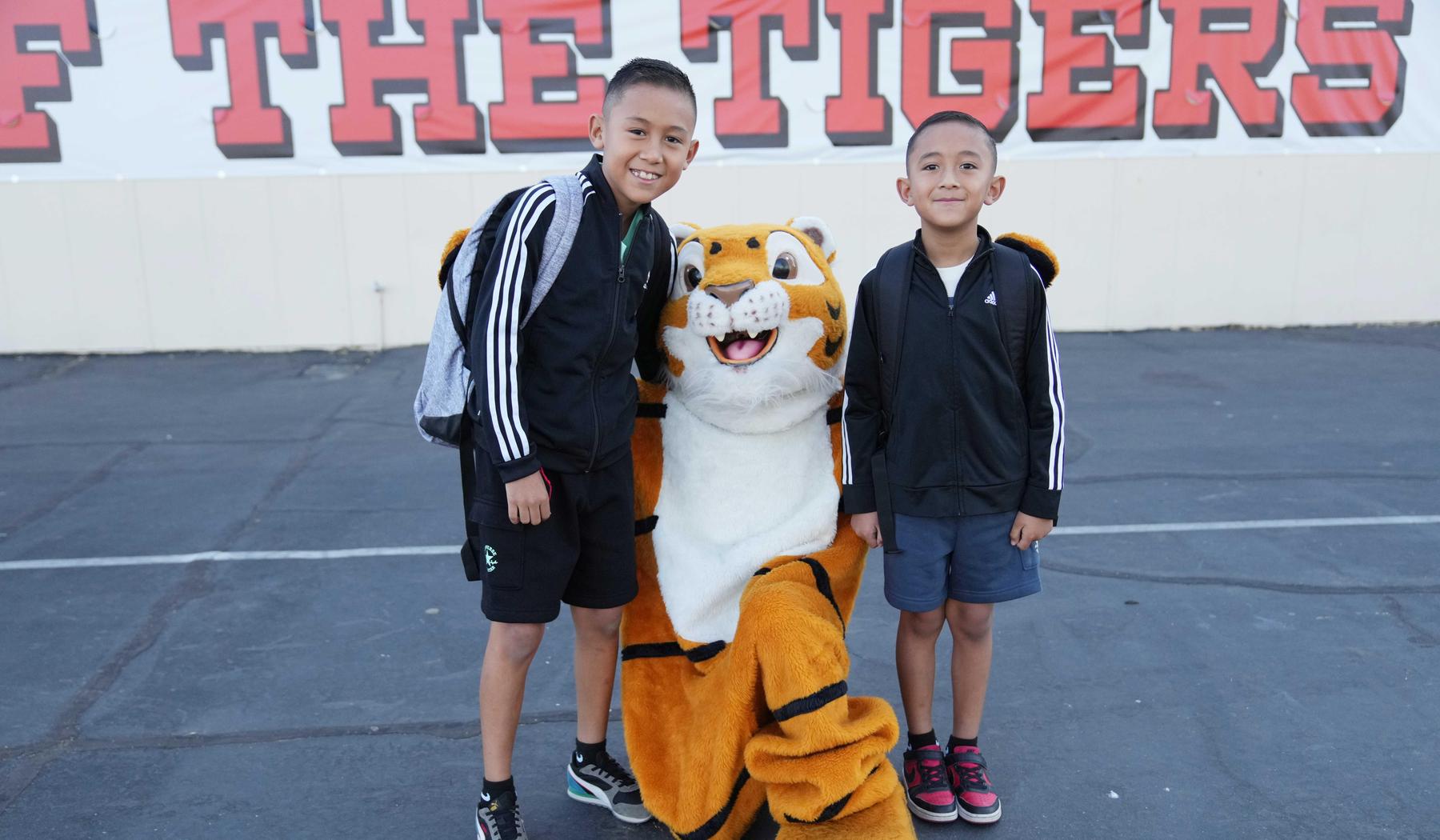 Two boys with mascot, Mr. Whiskers