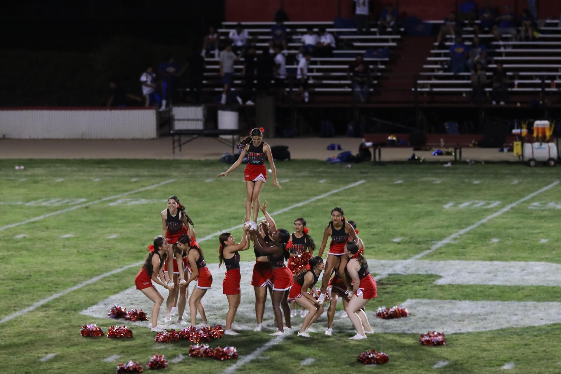 Varsity girls cheering at the Parlier football game