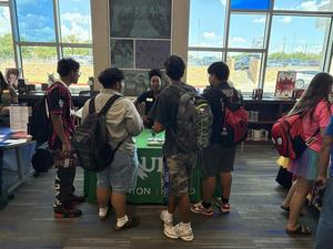 Students crowd around the UNT booth