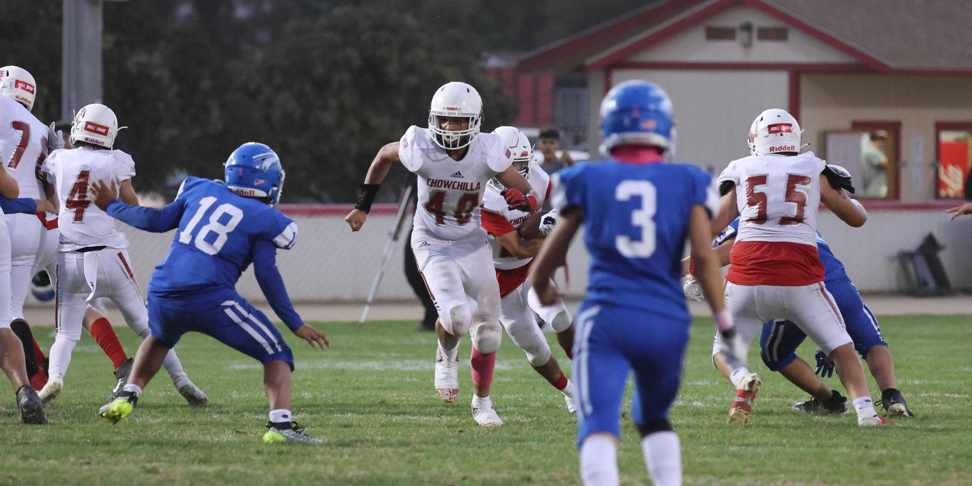 Junior Varsity football players in action against Caruthers