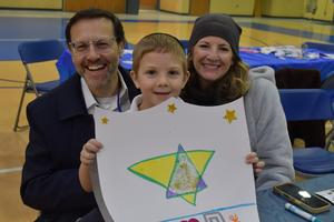 A family working on their family shield