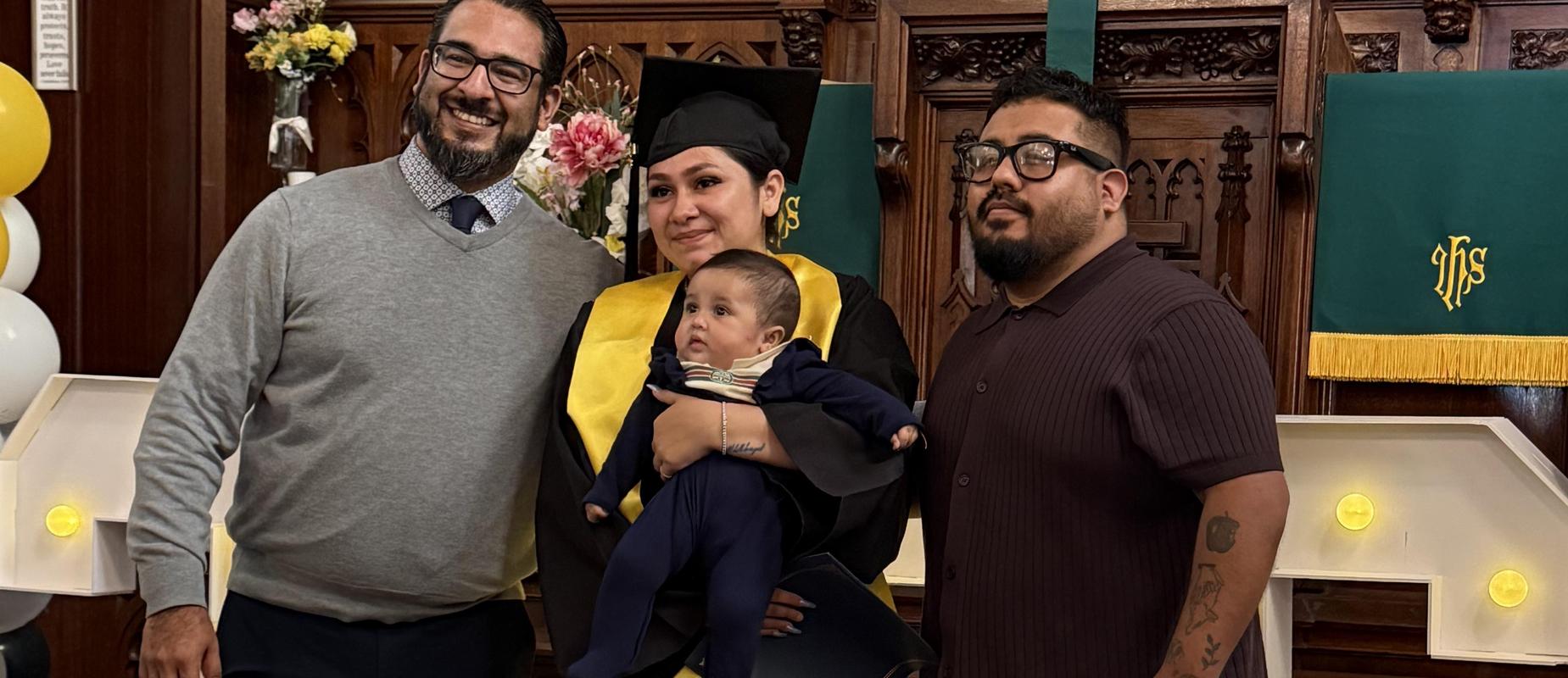 Graduate Yasmin poses with her baby, Mr. Rodriguez on the left and Mr. Kenny on the right