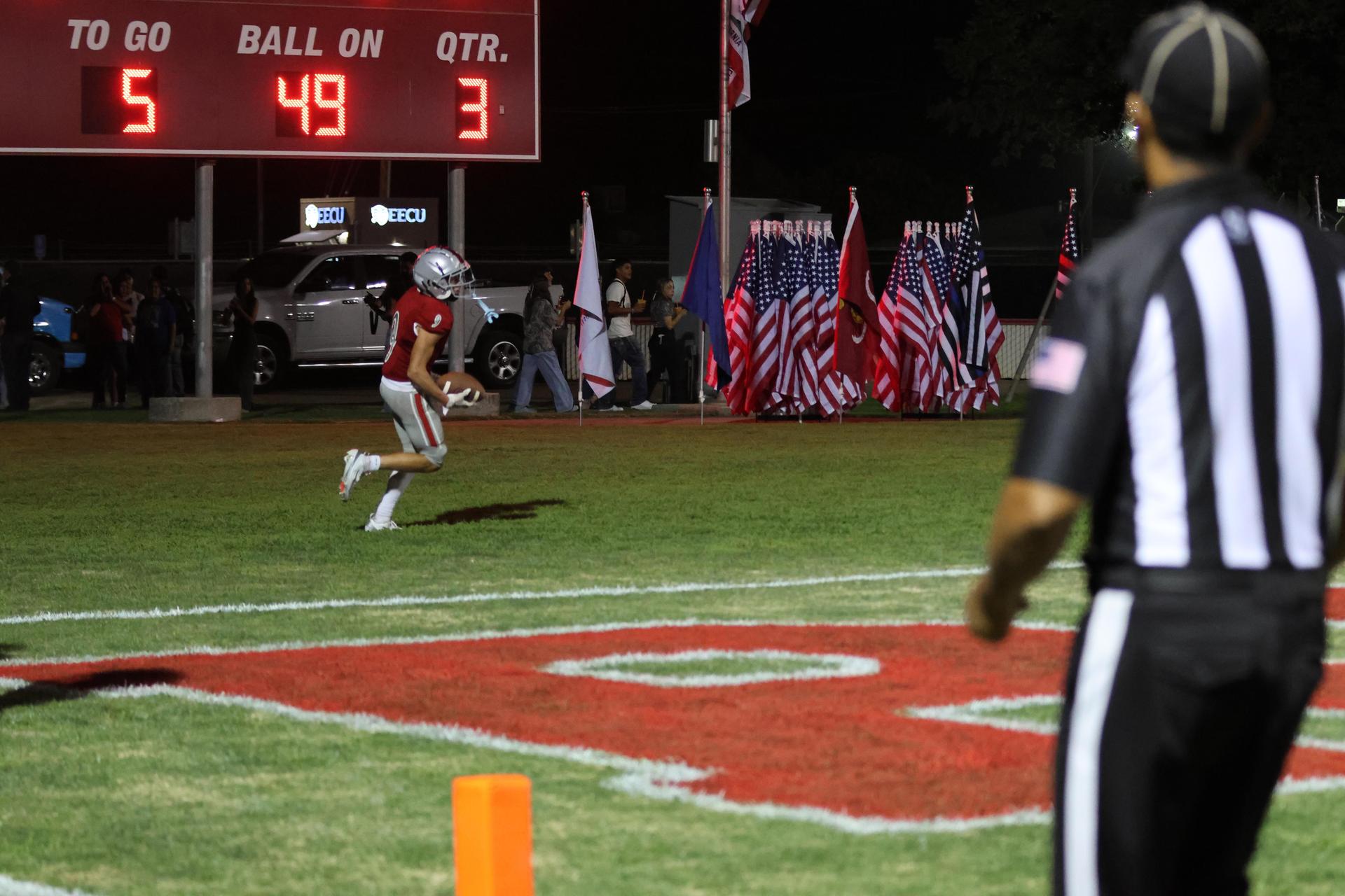 Varsity football players in action against Parlier 16