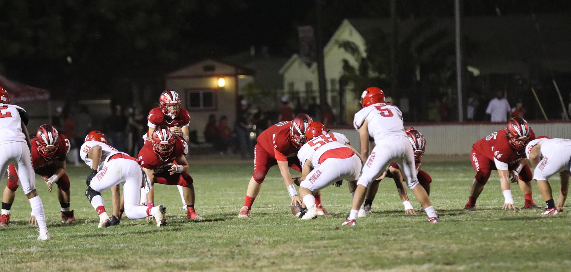 varsity boys playing football against Fowler