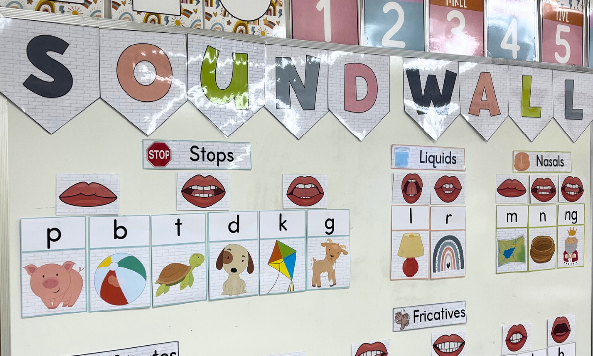 Kindergarten students practicing phonics with whiteboards