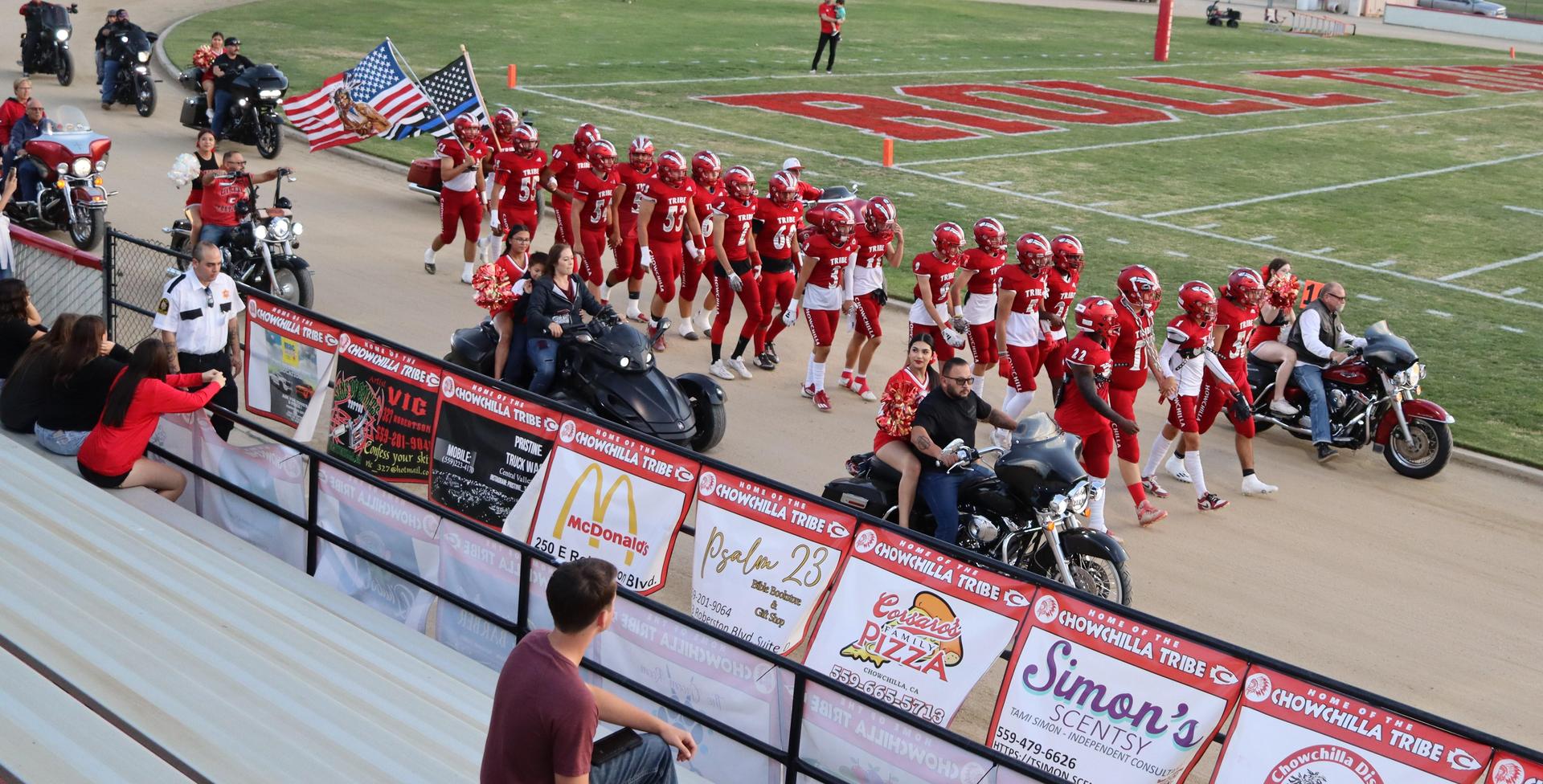 students, staff, and community members enjoying Friday night at the football game