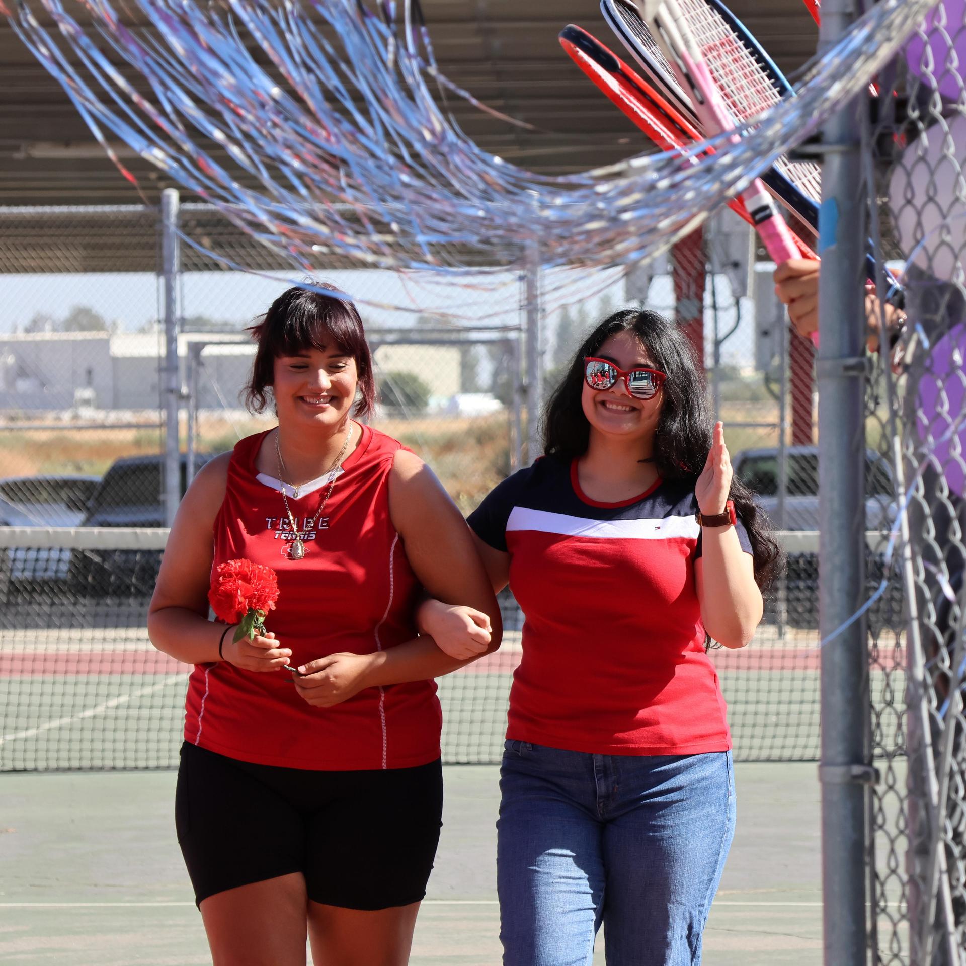 tennis players, family, and staff celebrating senior night