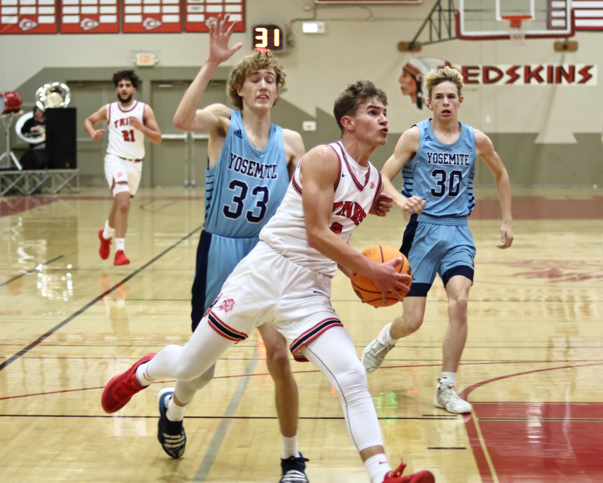 Varsity boys playing basketball against yosemite