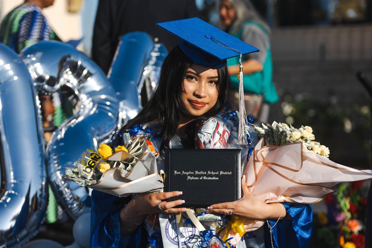 Graduate With Multiple Bouquets