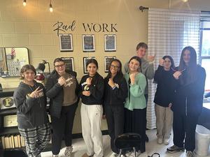 Students showing off their glow in the dark bracelets