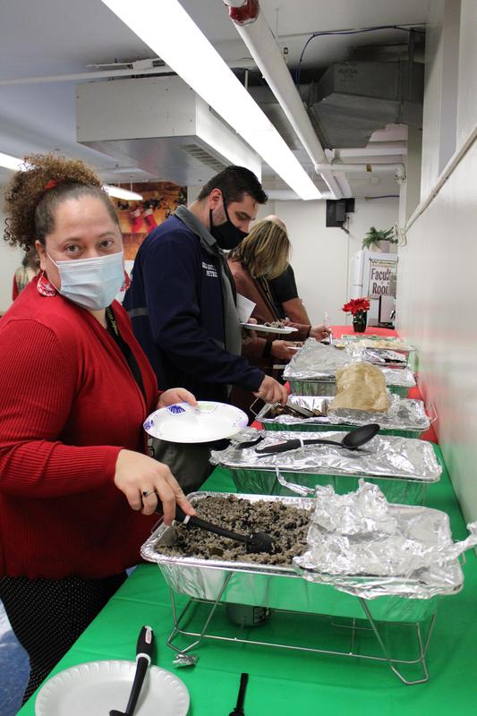 Teacher looking at camera as she serves herself food