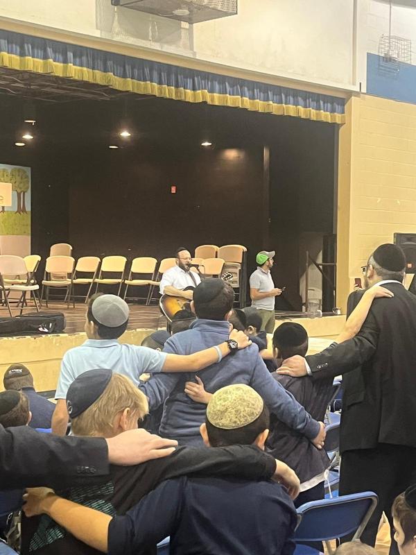 Middle School Boys watching Eitan Katz Perform