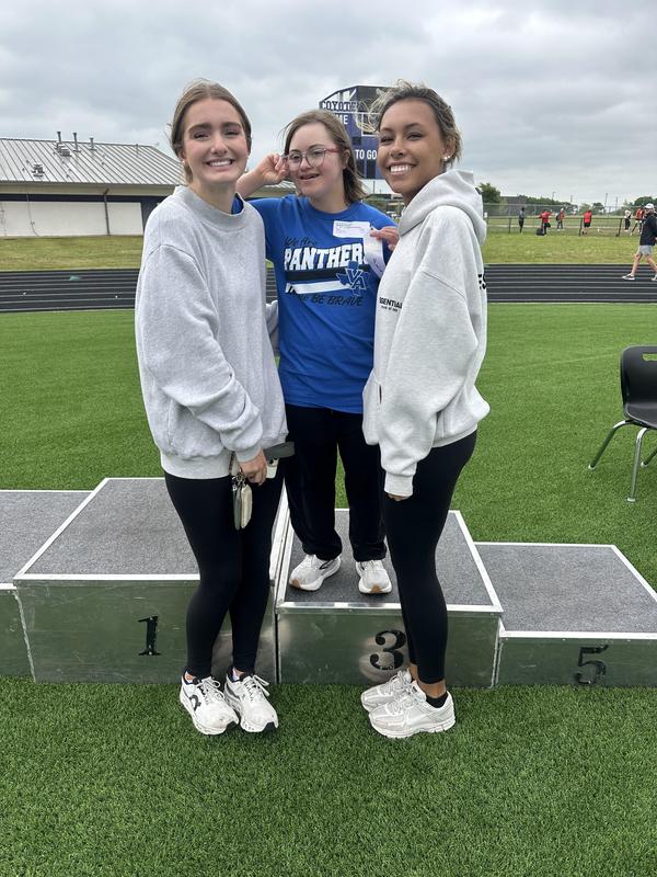 Unstoppable Athletes showing off their medals and posing with their VAHS Partners after their track meet in Anna