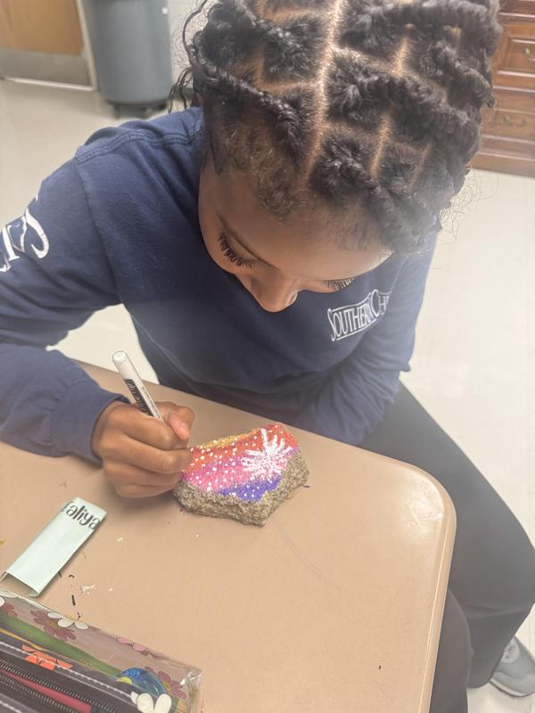 Student painting rock