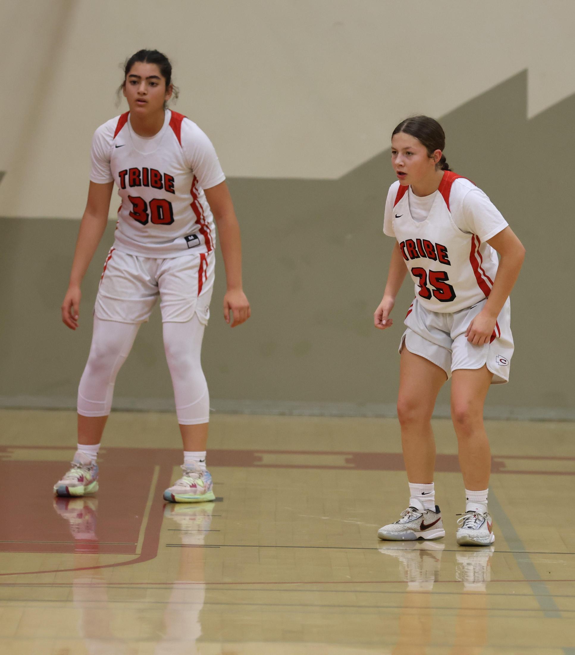 varsity girls playing basketball against mclane