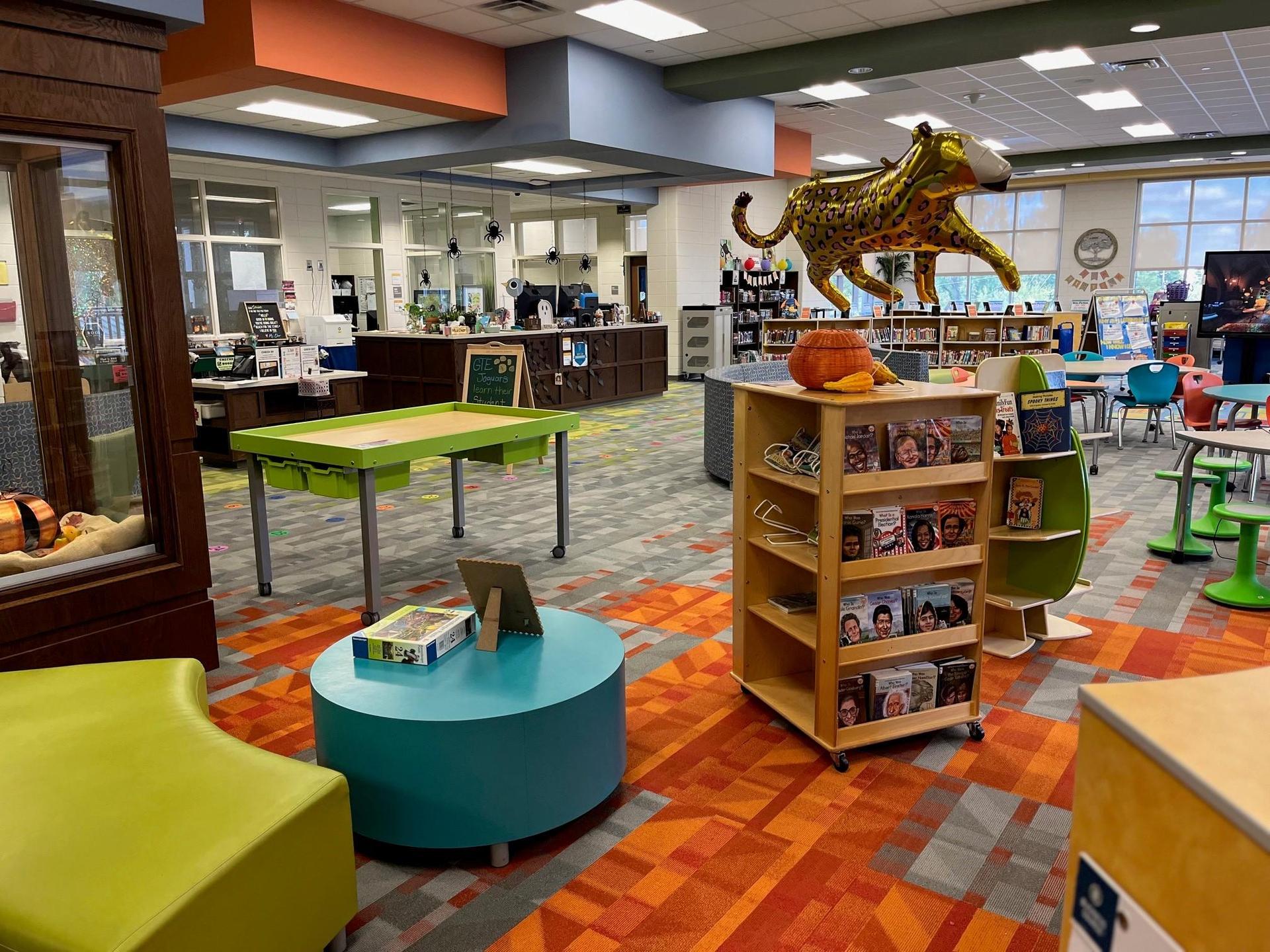 Grovetown Learning Commons space including tables, chairs, and shelves of books.
