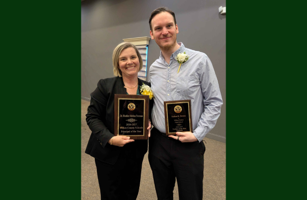 Two People posing with their awards