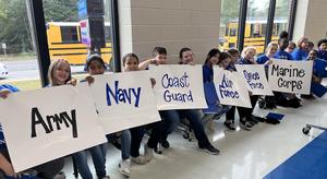 Students hold signs during last year’s Veterans Day program at Congaree Elementary.