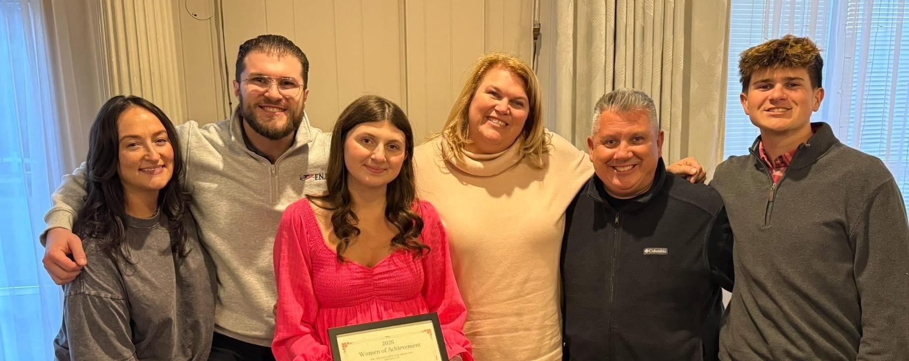Woman of Achievement Award winner with her family