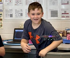 Students working with drones in a STEAM classroom.