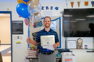 jon sides with balloons and certificate for being the teacher on the rise winner
