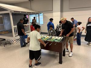 Mentors and mentees play in the game room