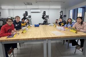 A group of students sitting around a long table