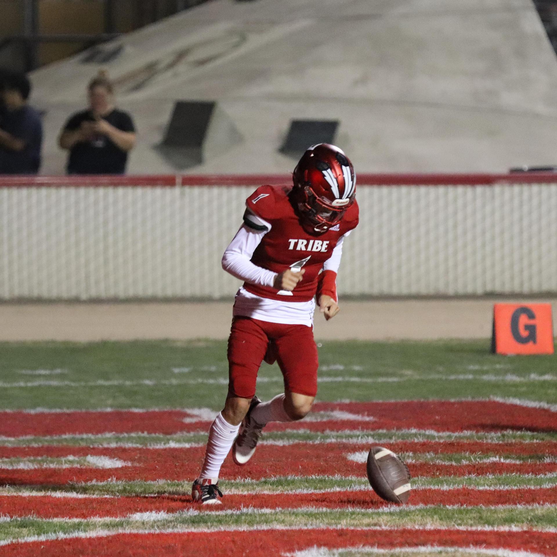 varsity football players in action against Riverdale