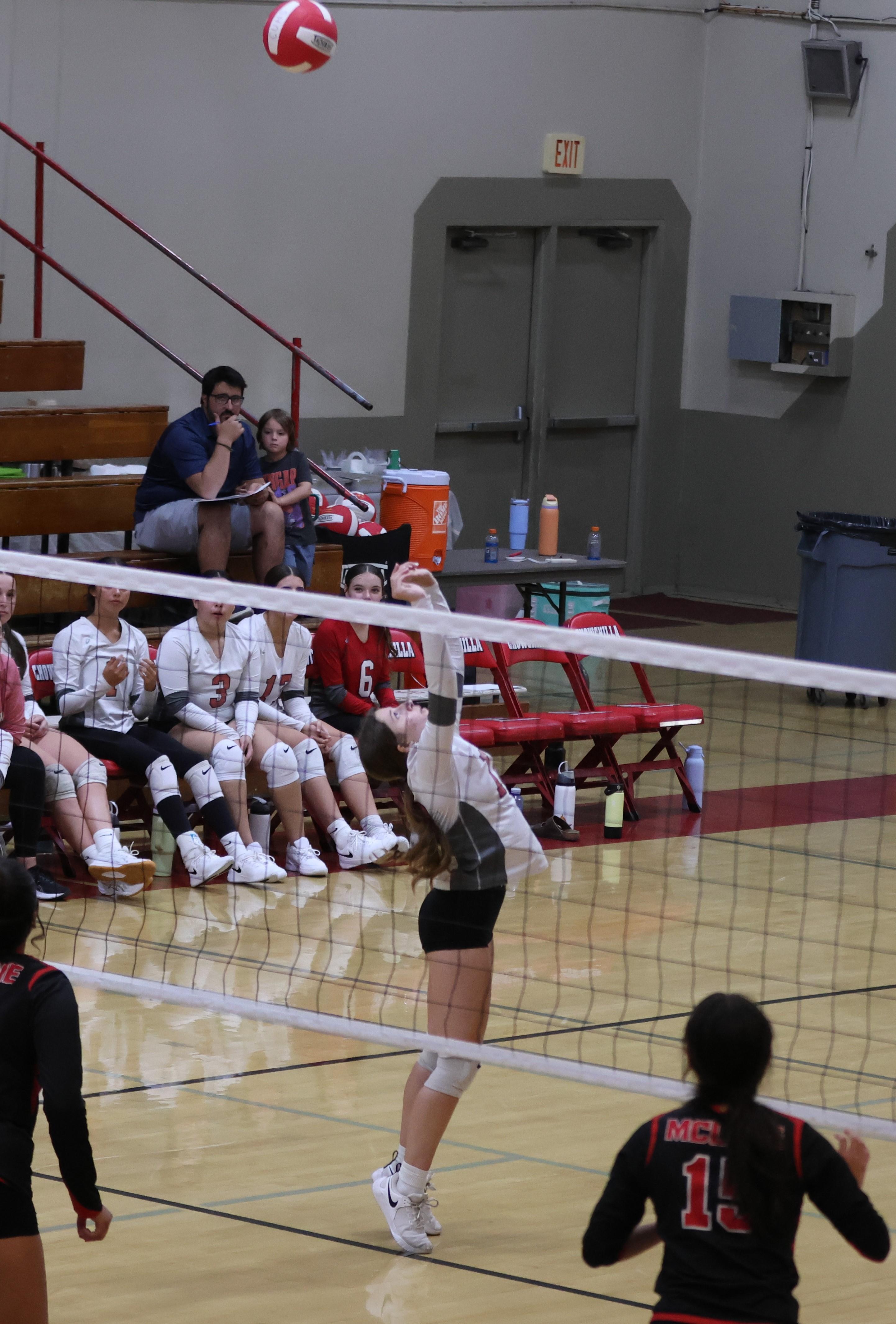 junior varsity girls playing volleyball 95