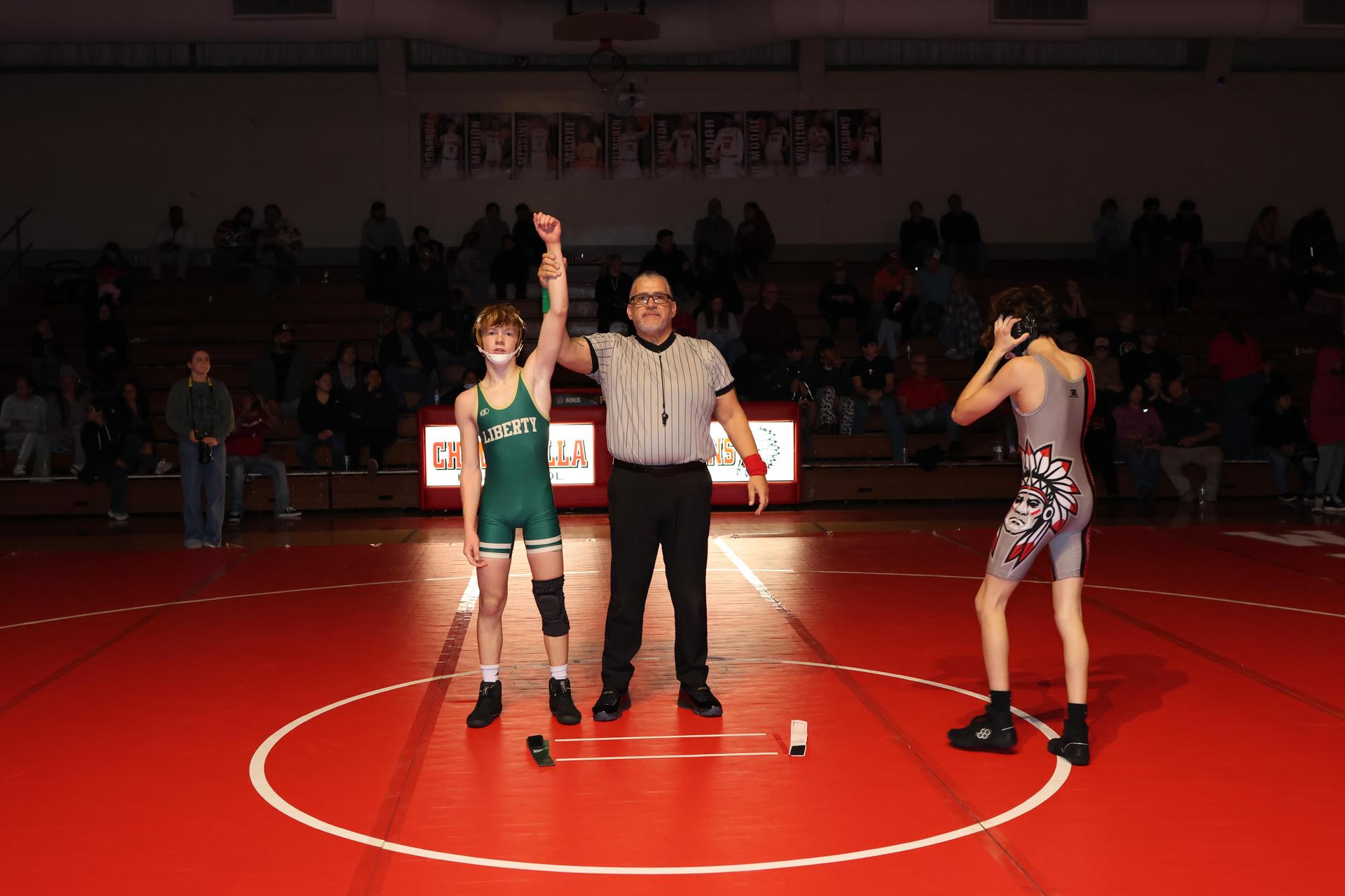 Wrestling winners with hands up 111