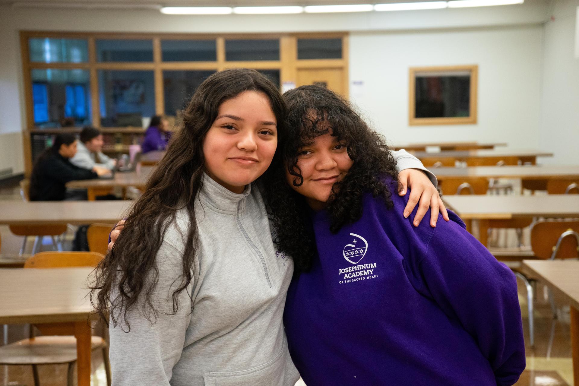 Students hugging and posing for camera