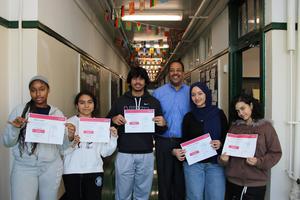 Students holding COMPTIA Tech+ certificates