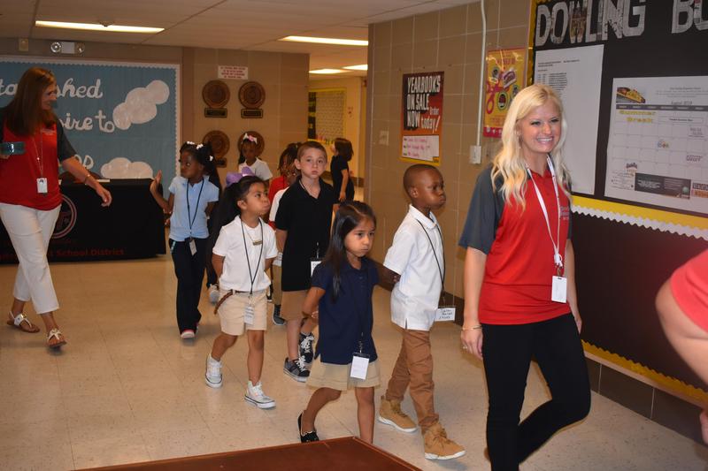 students and teacher in school hallway