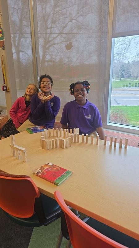 Scholars in the library with dominos