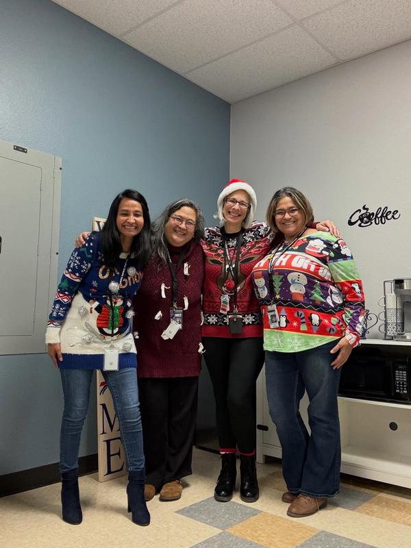 staff in Christmas sweaters