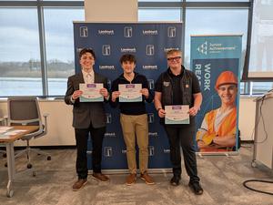 students holding up awards