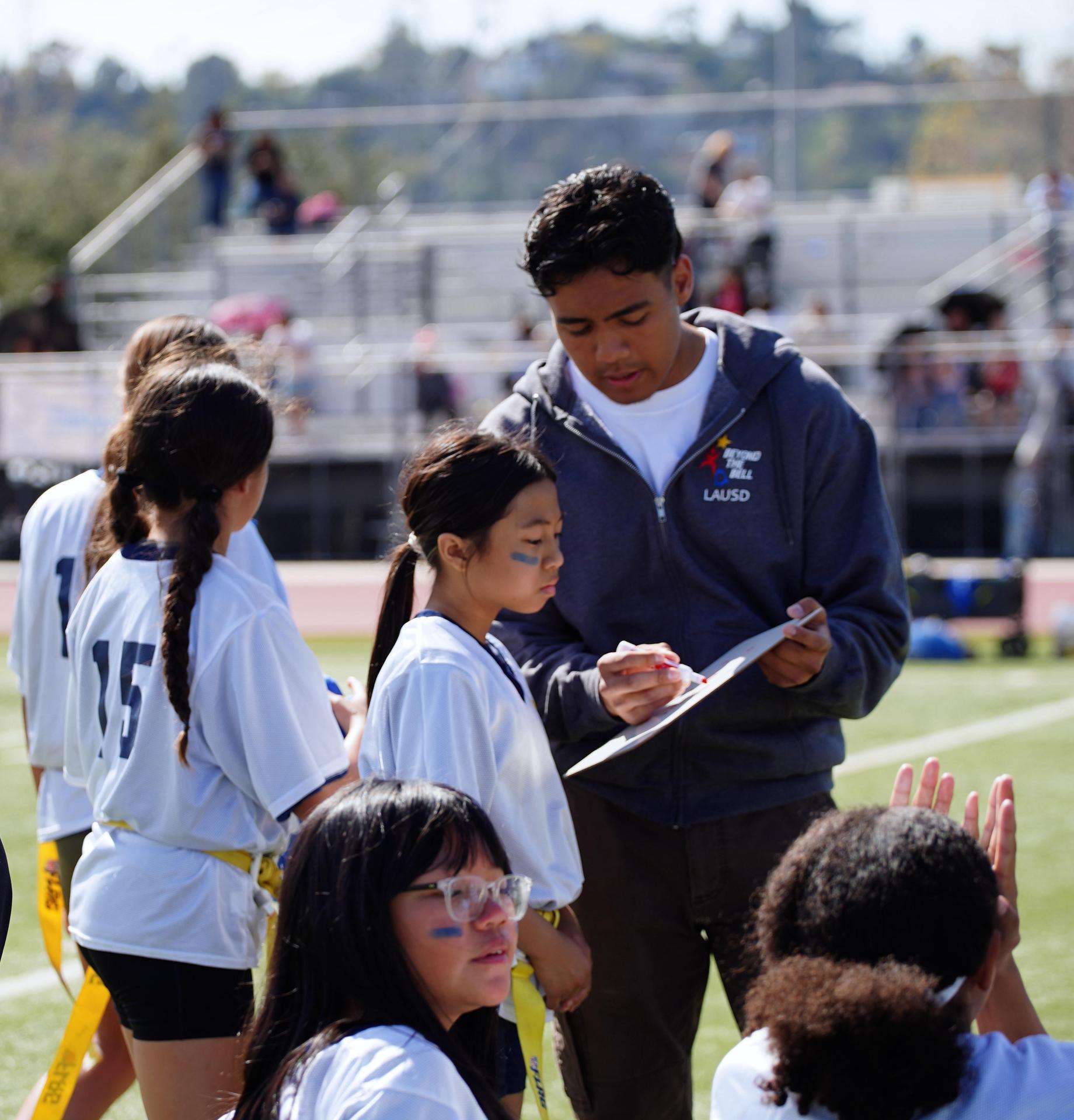 sports coach explaining something to student