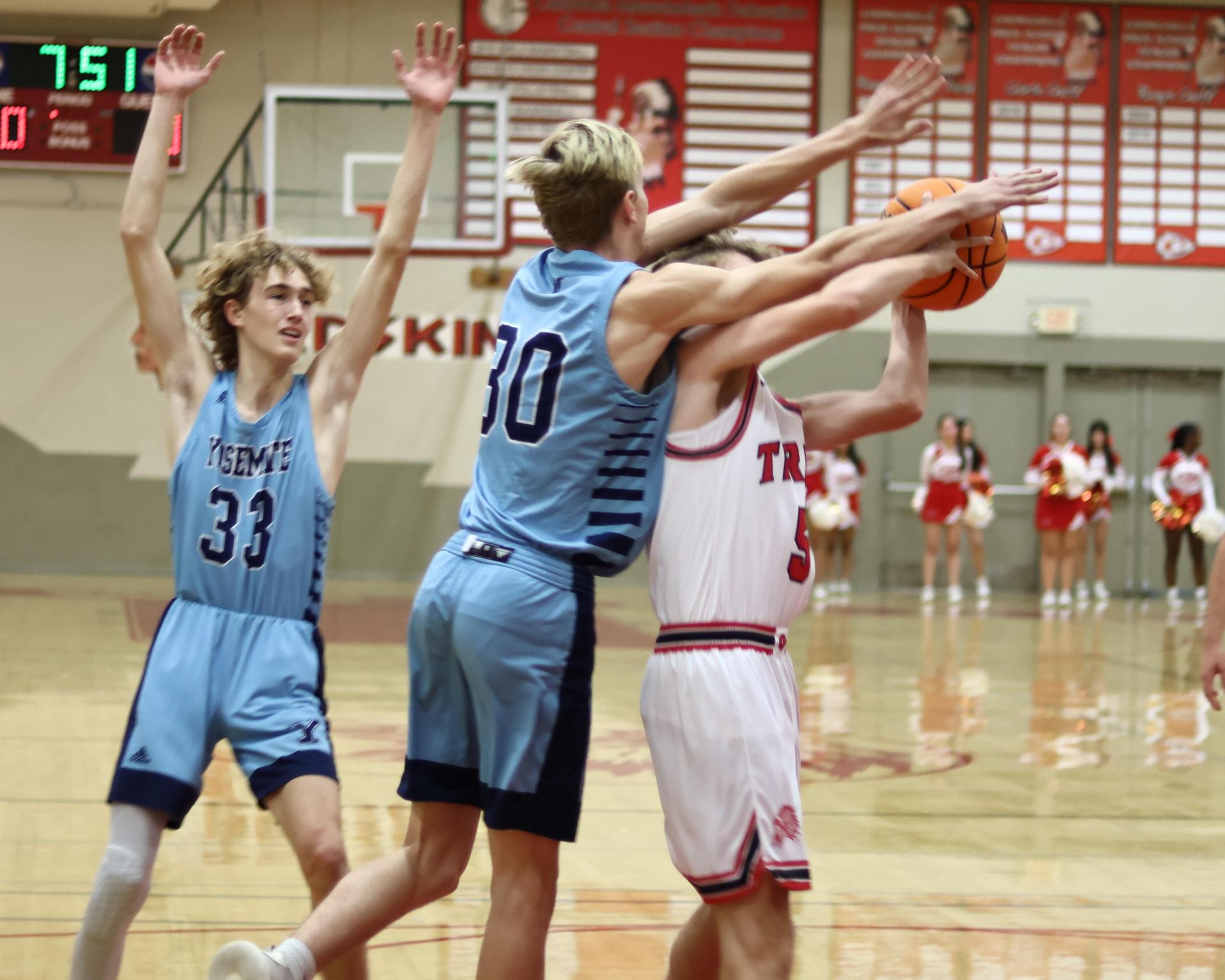Varsity boys playing basketball against yosemite
