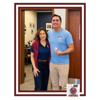 Photo of a woman and a man holding an award