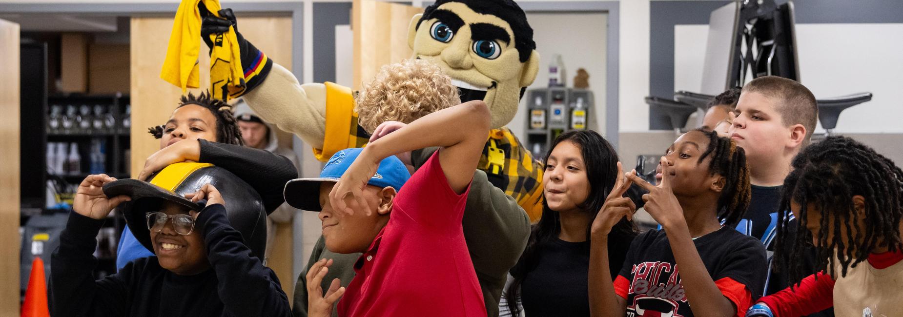 Middle school students pose with the Steelers mascot