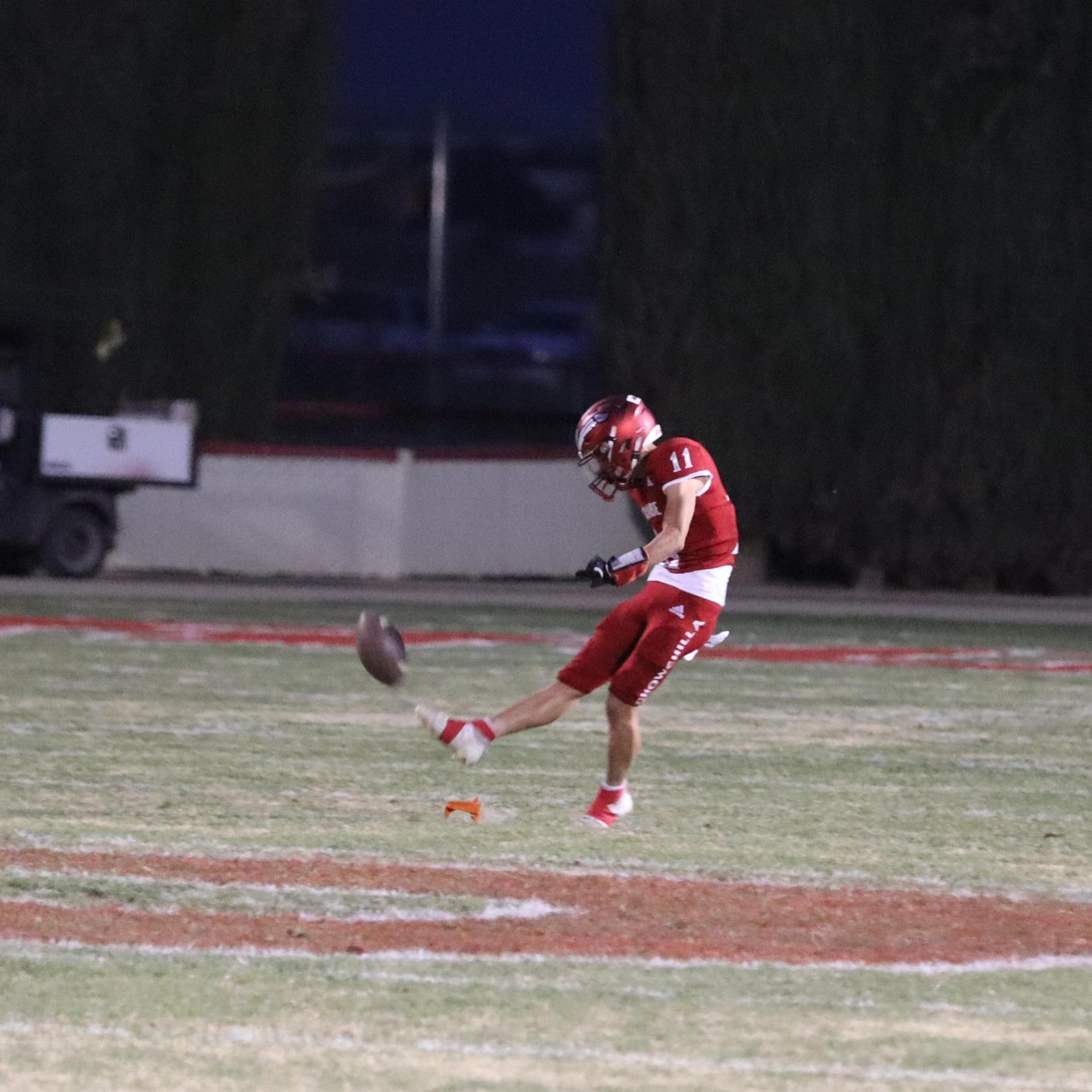 varsity football players in action against Riverdale