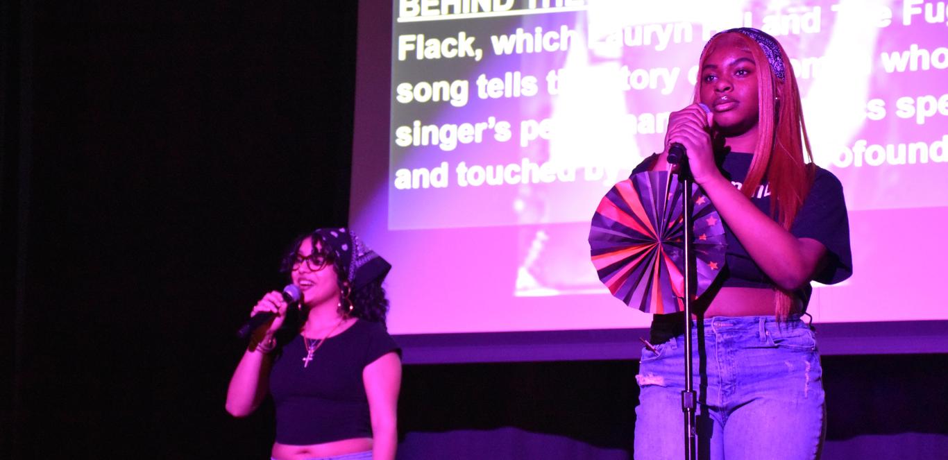 Two students singing in the Black History Month assembly.